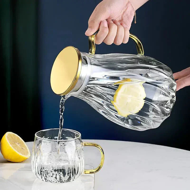 Set med dryckeskanna i glas med lock i rostfritt stål samt matchande koppar