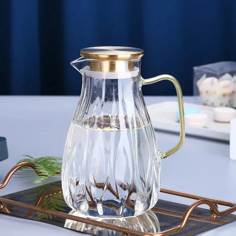 Set med dryckeskanna i glas med lock i rostfritt stål samt matchande koppar