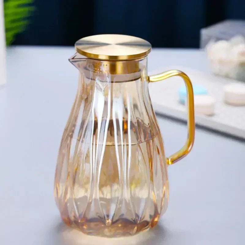 Set med dryckeskanna i glas med lock i rostfritt stål samt matchande koppar
