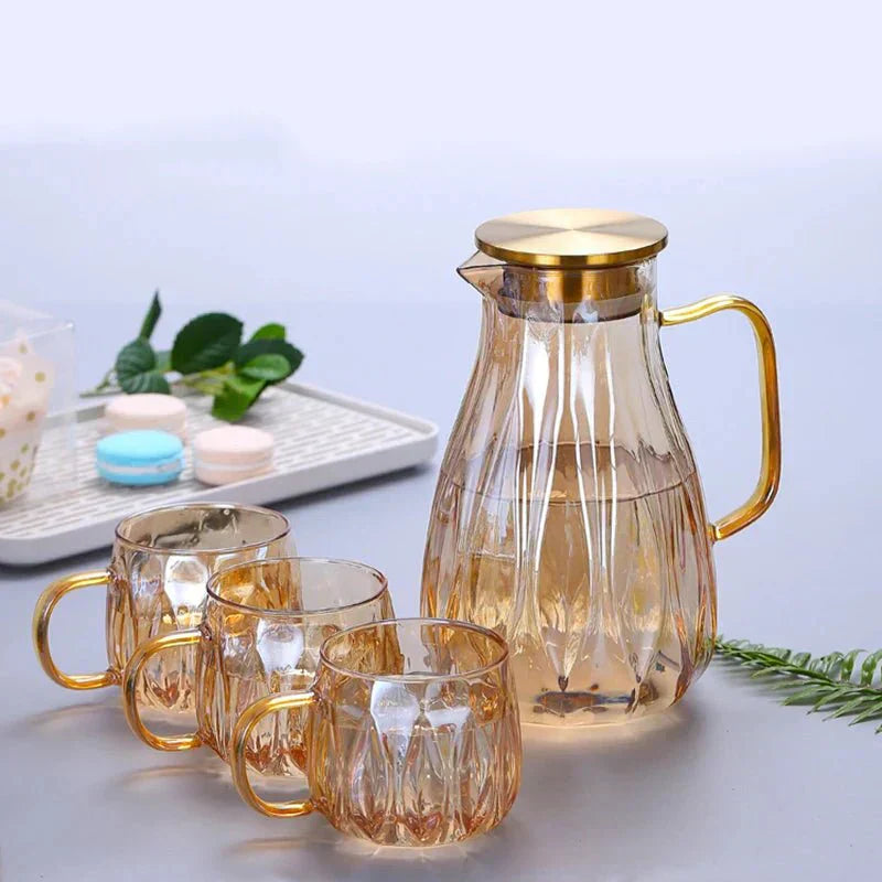 Set med dryckeskanna i glas med lock i rostfritt stål samt matchande koppar